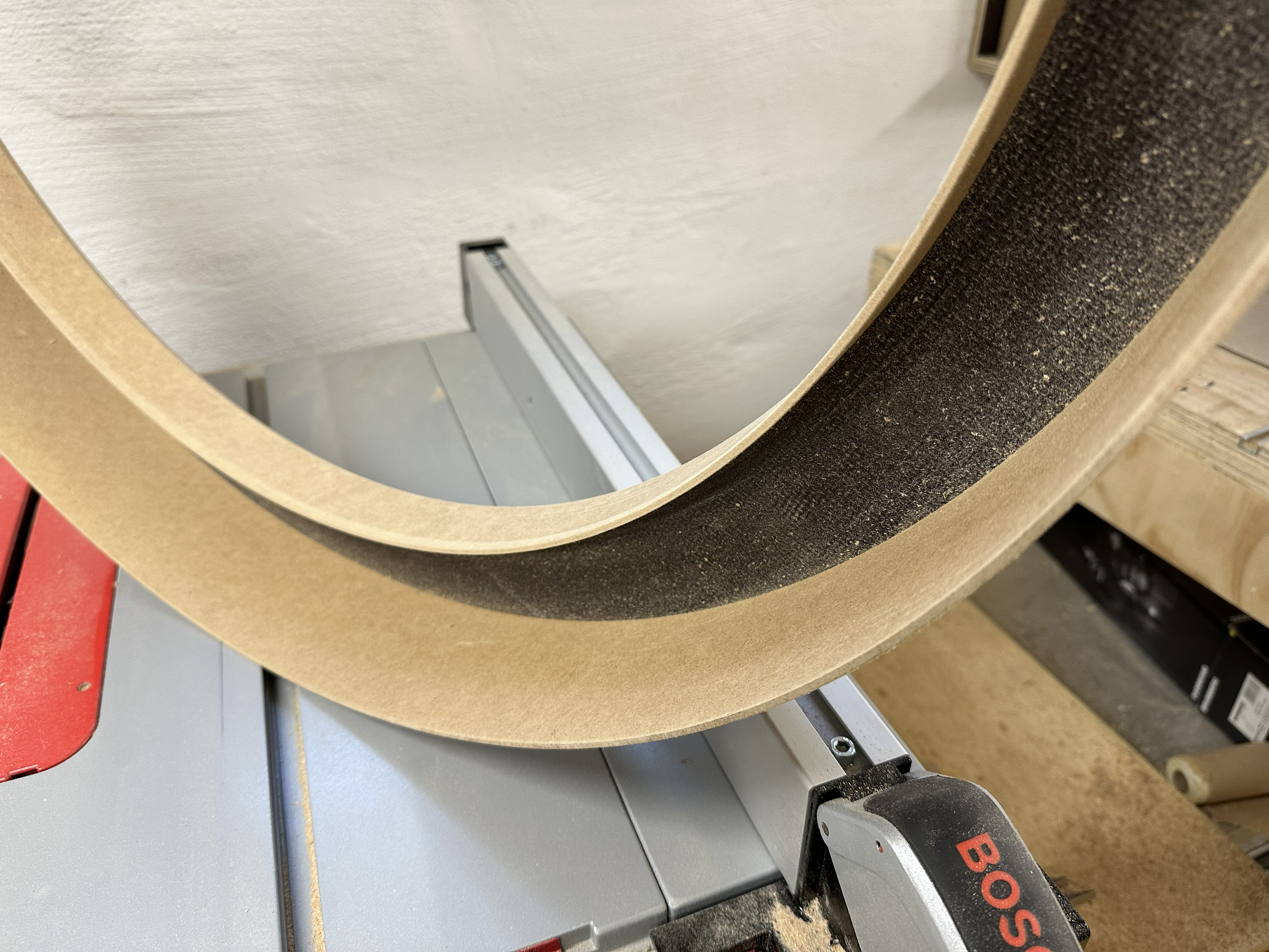Curved wooden frame of the one-metre ring light under construction in the workshop