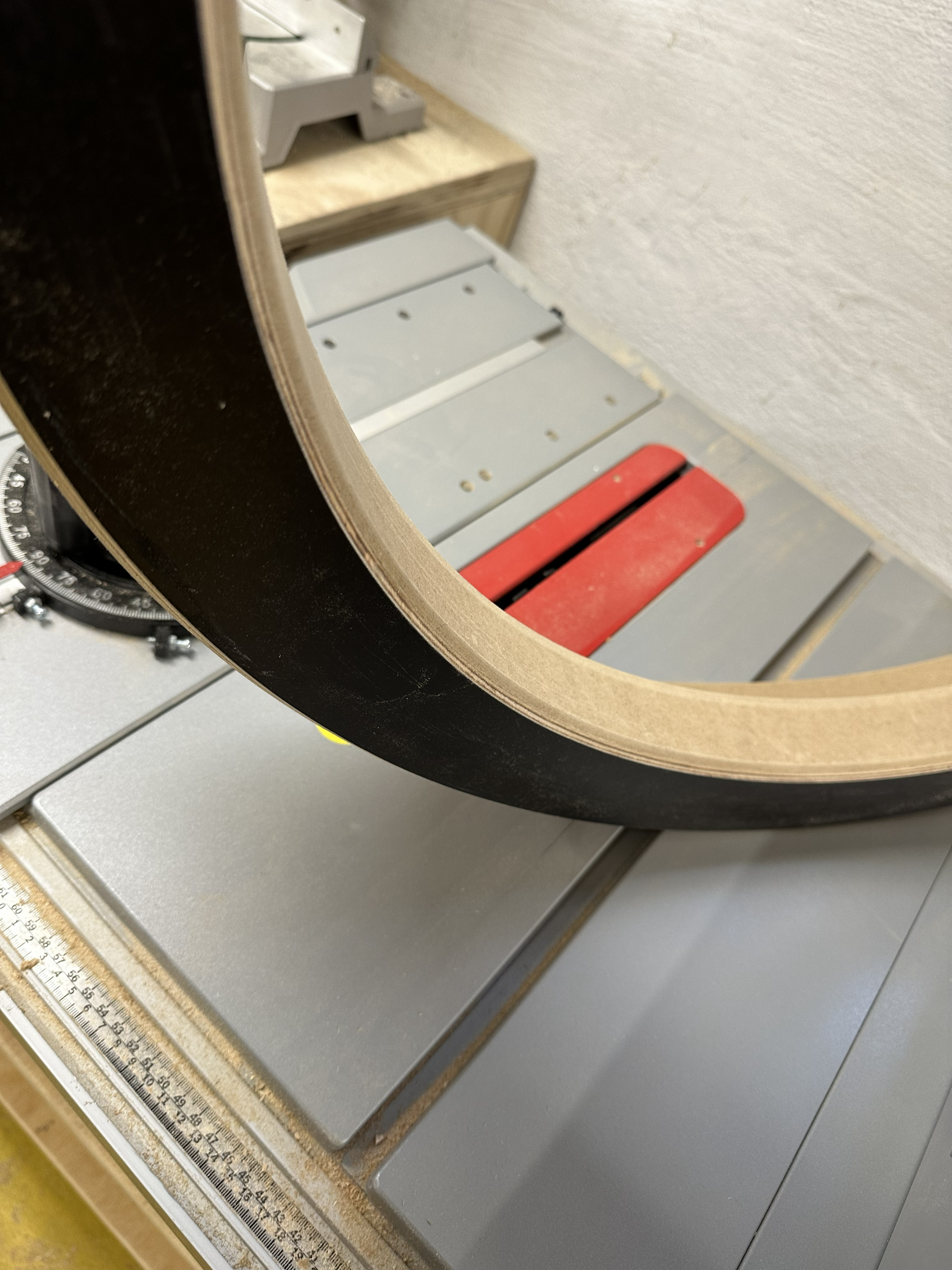 Workshop detail of the ring light's curved wooden frame