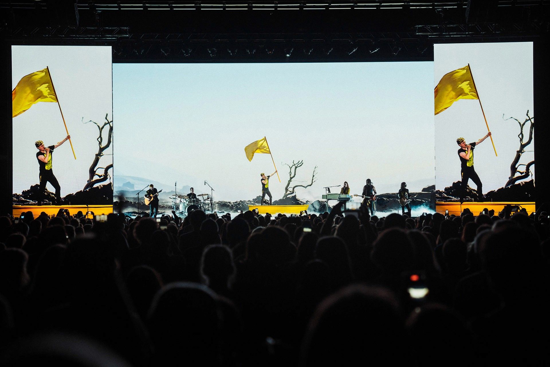 Michael Patrick Kelly B.O.A.T.S. Tour: flags waving on stage in front of a sky-blue LED wall