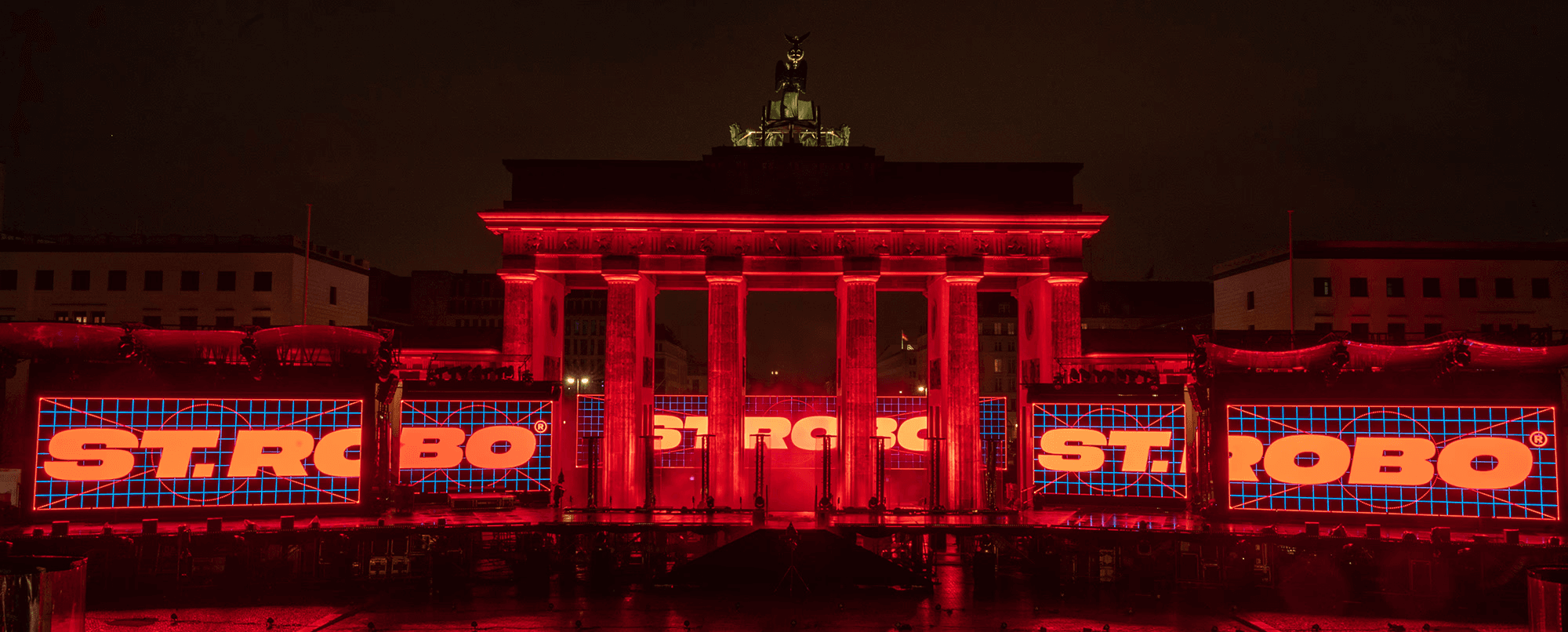 Brandenburg Gate lit in red behind the New Year's Eve stage
