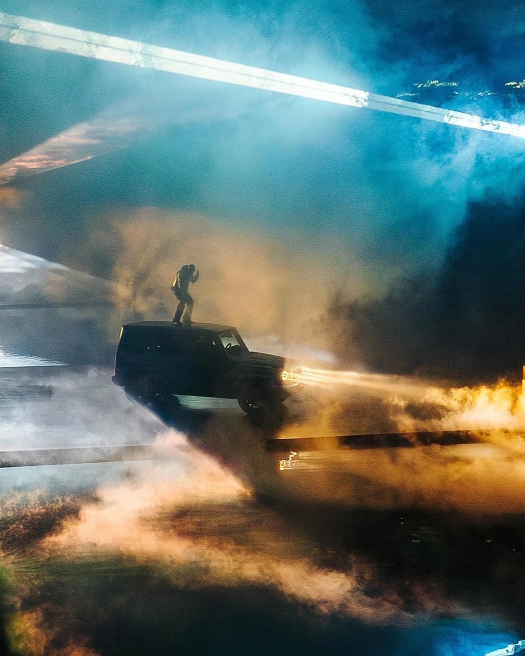 Mercedes-Benz G 580 on stage in blue and orange light and smoke