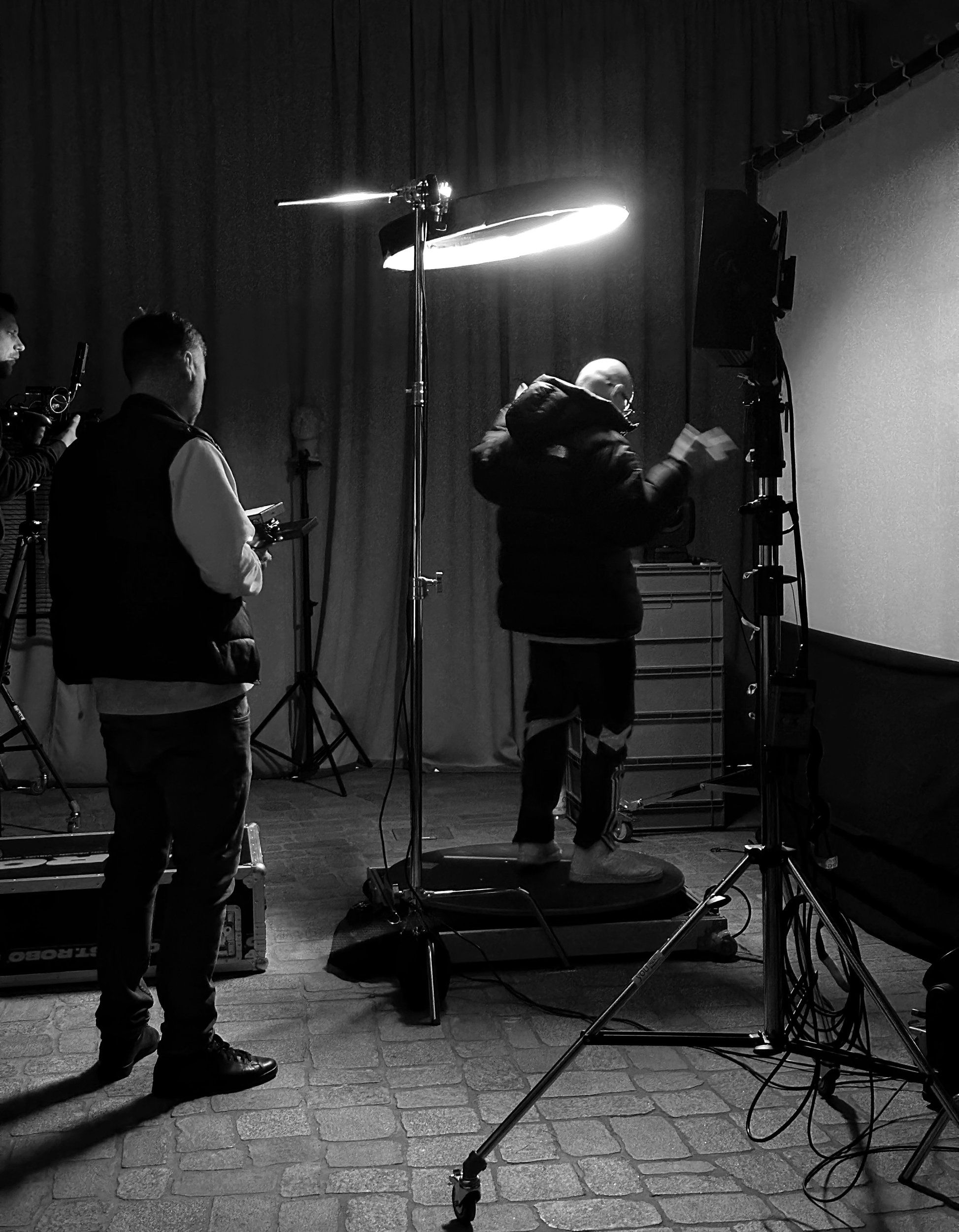 Crew and camera set-up around the ring light in the studio