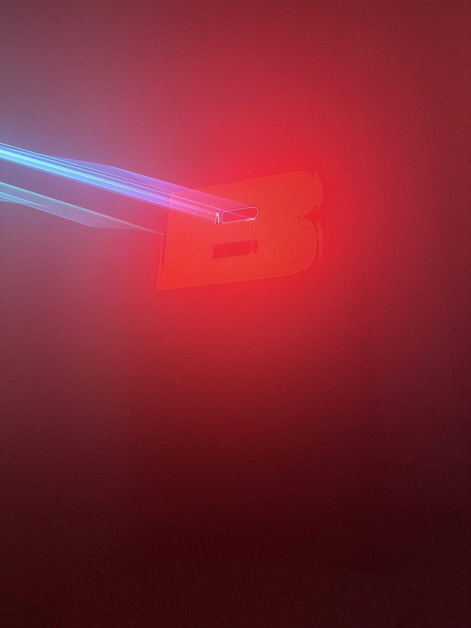 Laser beams hitting a glowing red letter in haze, ZPACE laser test