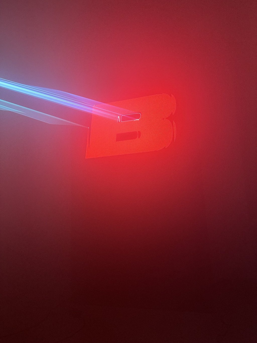 Laser beams hitting a glowing red letter in haze, ZPACE laser test