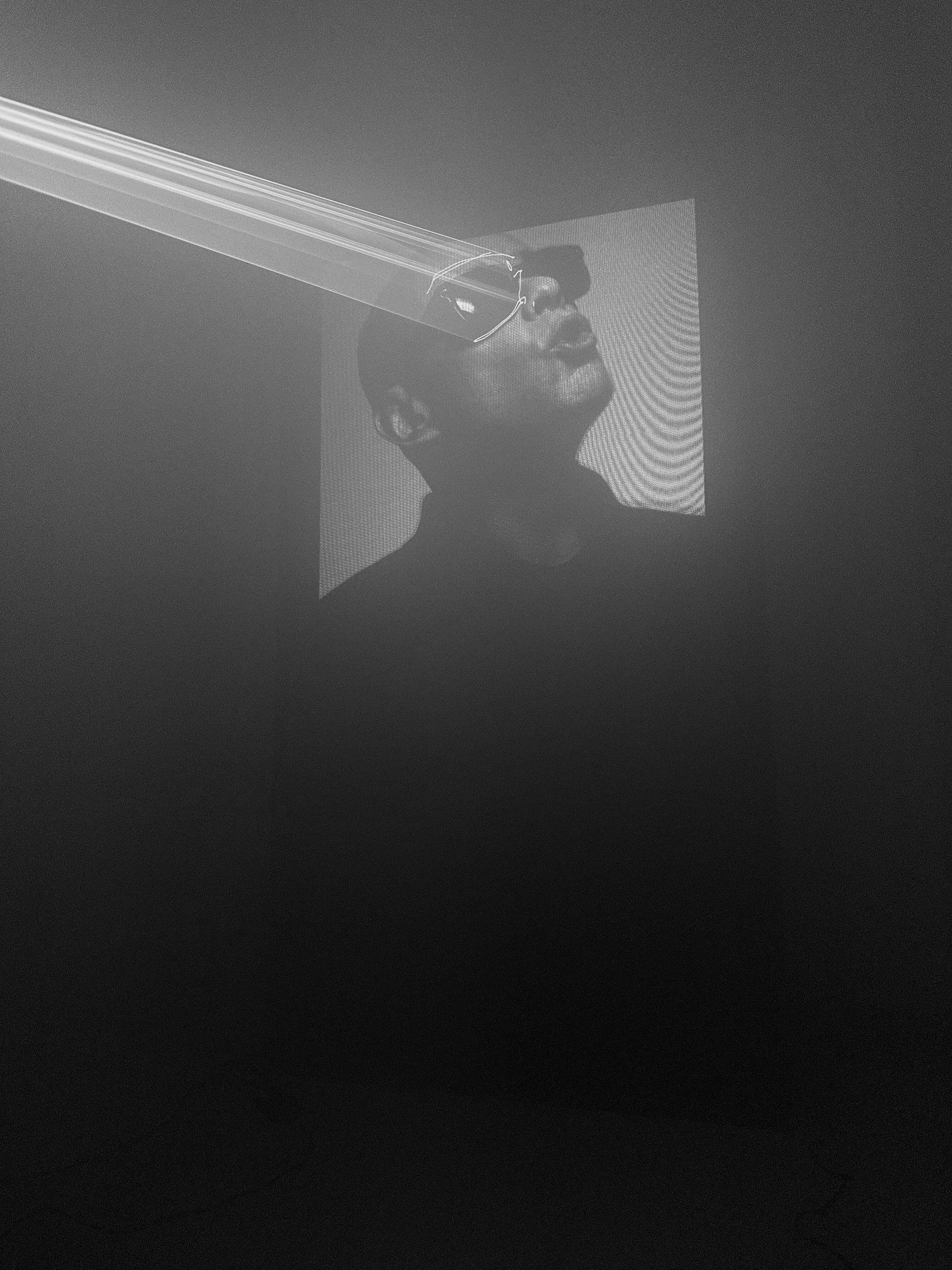 Laser beam sweeping across a person in haze